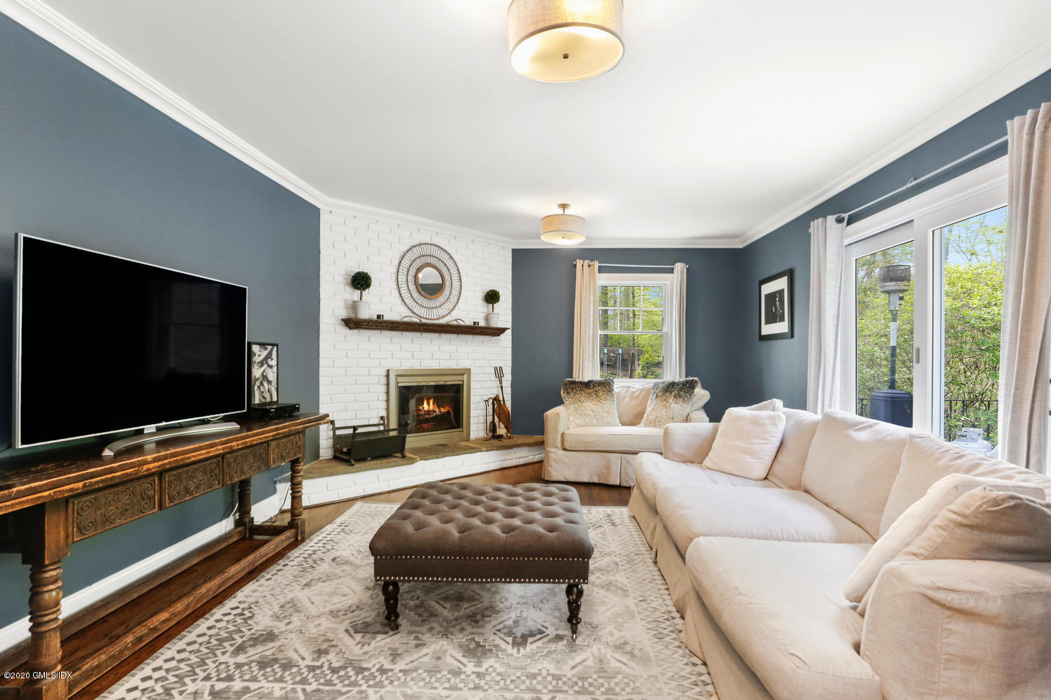 277 Cognewaugh Road Cos Cob, CT 06807 - Photo 12 of 34 a living room with furniture flat screen tv and a fireplace