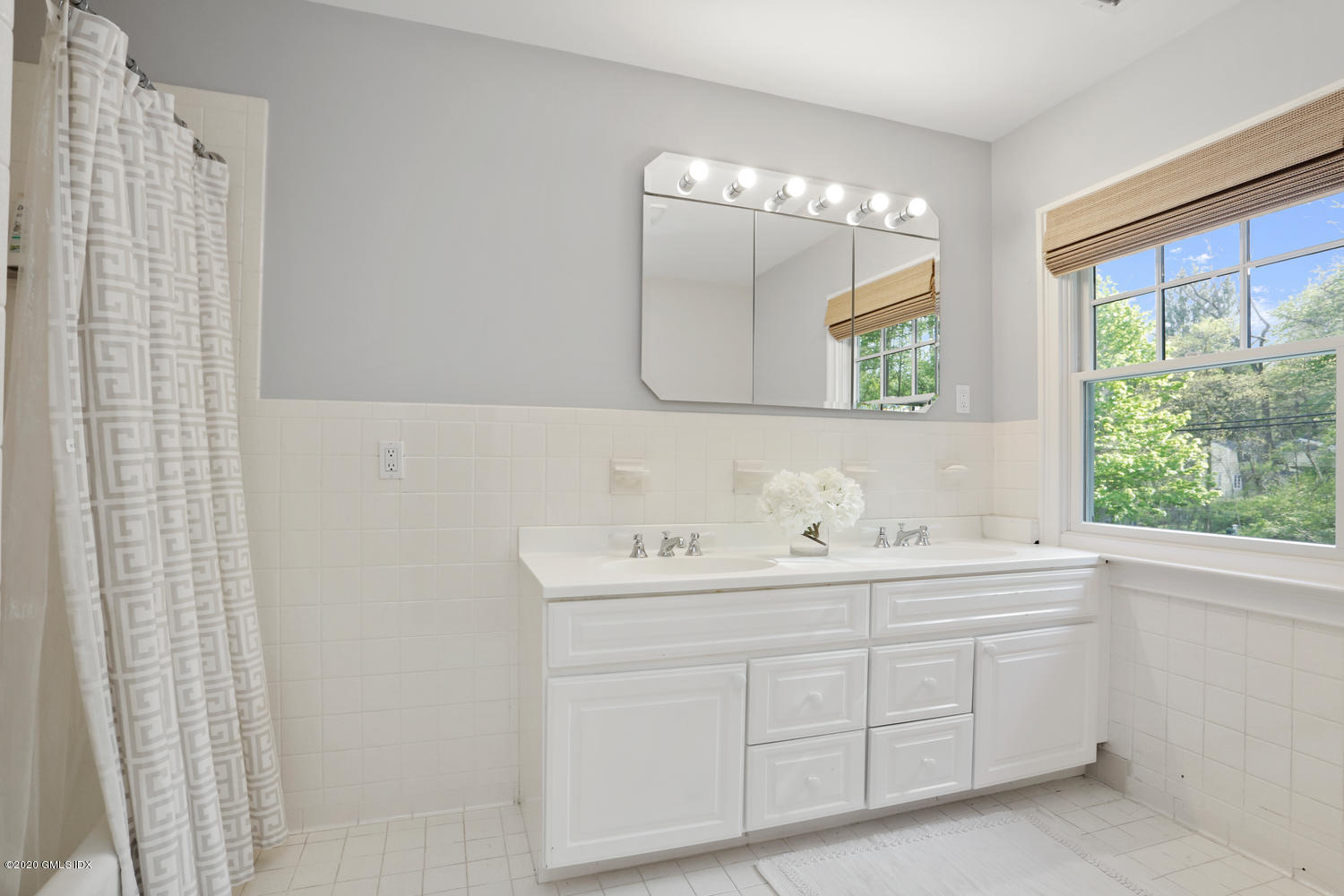277 Cognewaugh Road Cos Cob, CT 06807 - Photo 22 of 34 a bathroom with a double vanity sink and mirror