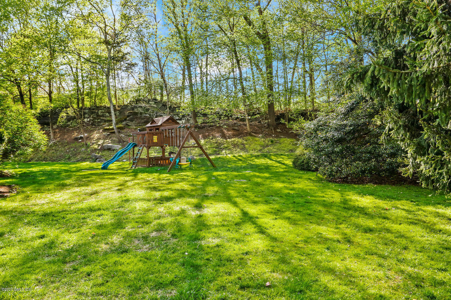277 Cognewaugh Road Cos Cob, CT 06807 - Photo 27 of 34 a view of a backyard with a slide