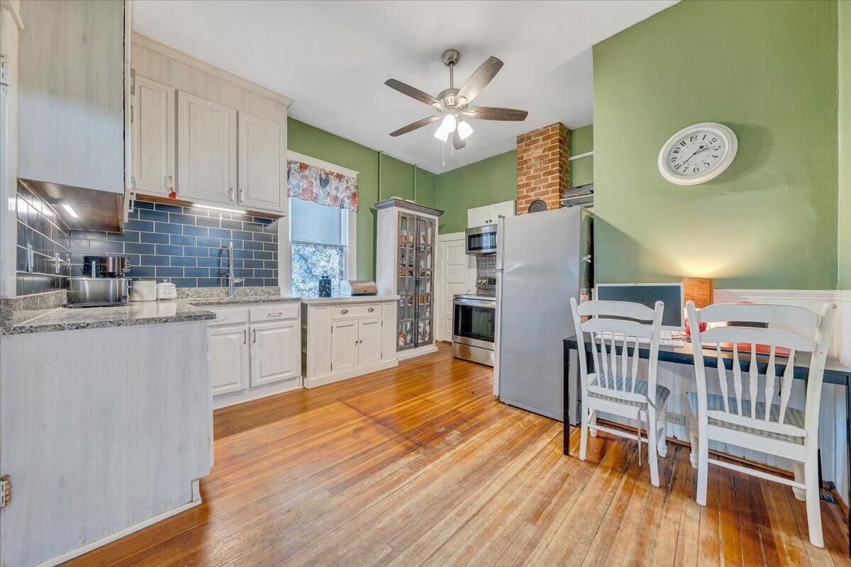 1307 Maple Avenue Southwest Roanoke, VA 24016 - Photo 23 of 53 a kitchen with stainless steel appliances granite countertop a microwave a stove and a wooden floors