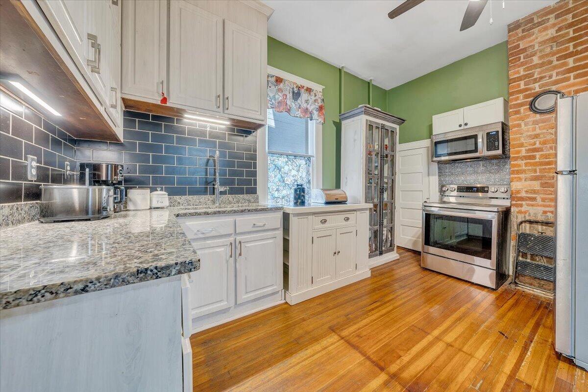 1307 Maple Avenue Southwest Roanoke, VA 24016 - Photo 24 of 53 a kitchen with stainless steel appliances granite countertop a sink a stove and cabinets