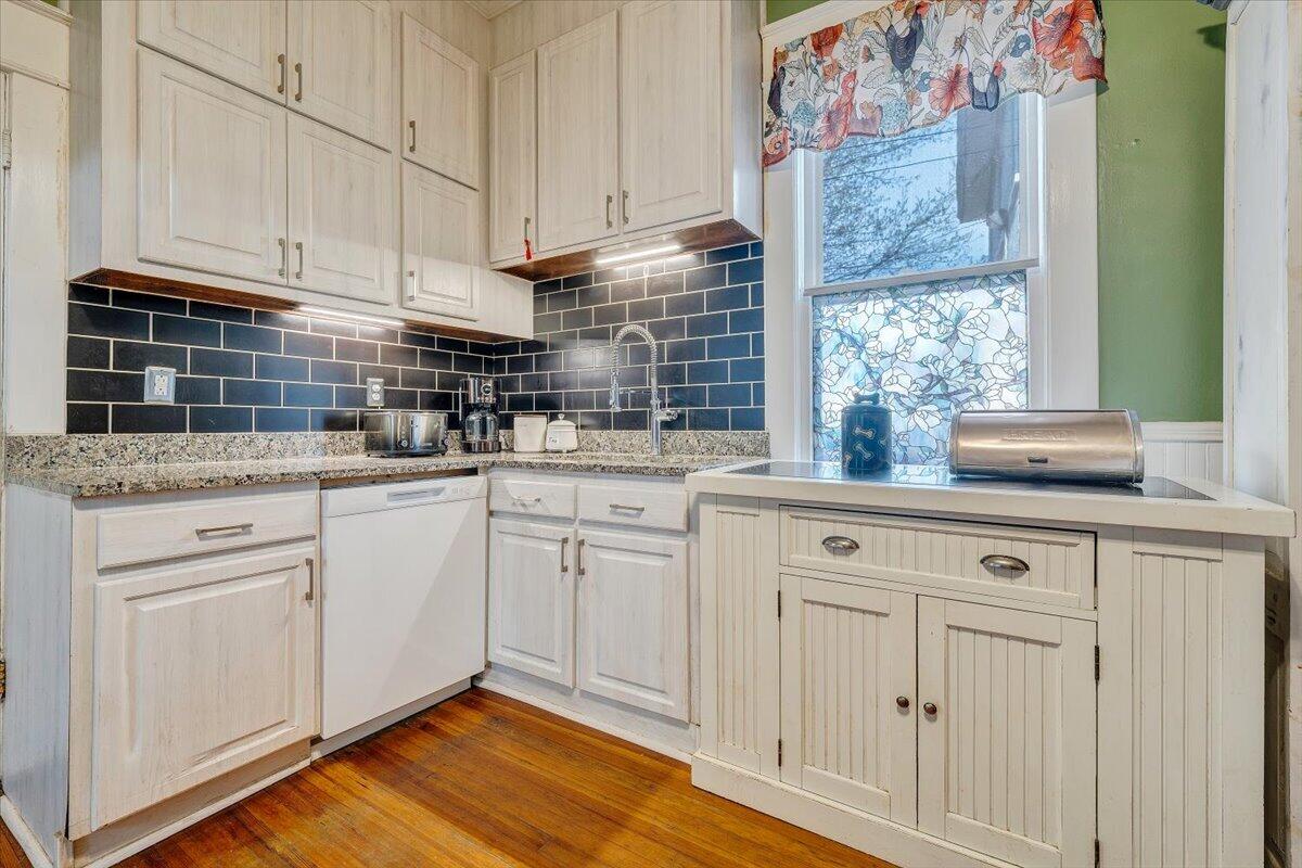 1307 Maple Avenue Southwest Roanoke, VA 24016 - Photo 26 of 53 a kitchen with stainless steel appliances granite countertop a sink a stove and cabinets