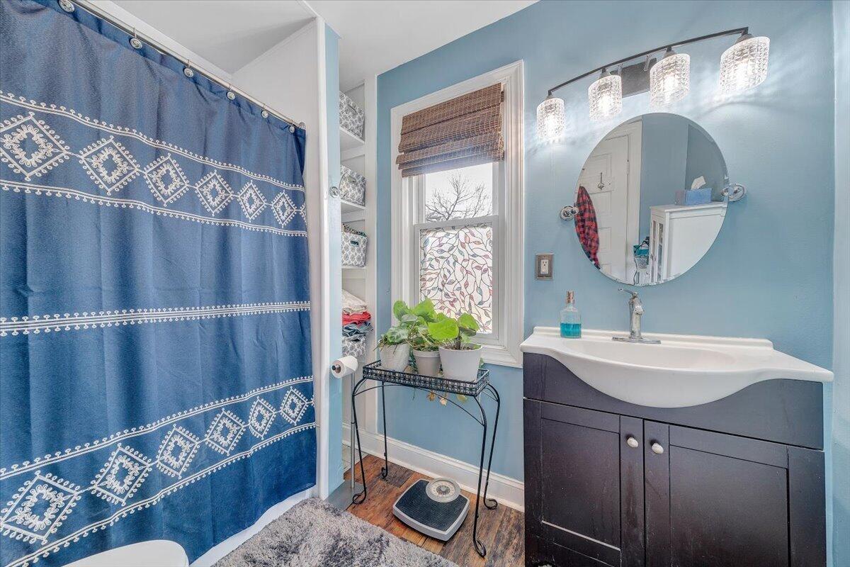 1307 Maple Avenue Southwest Roanoke, VA 24016 - Photo 40 of 53 a bathroom with a sink mirror and vanity