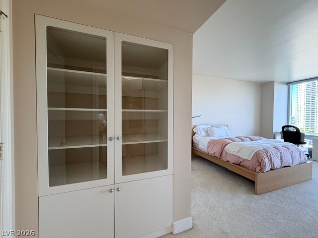 2777 Paradise Road, Unit 807 Las Vegas, NV 89109 - Photo 7 of 61 Restful bedroom retreat with a window showcasing city views and built-in shelving.