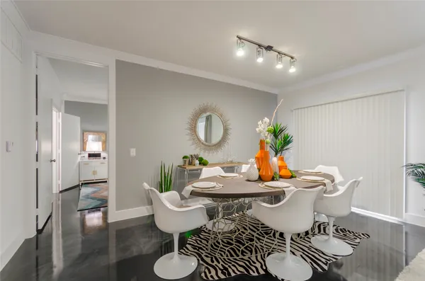 a dining room with furniture and wooden floor