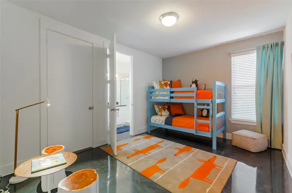 a children room with furniture and wooden floor