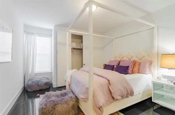 a bedroom with a bed and a tv