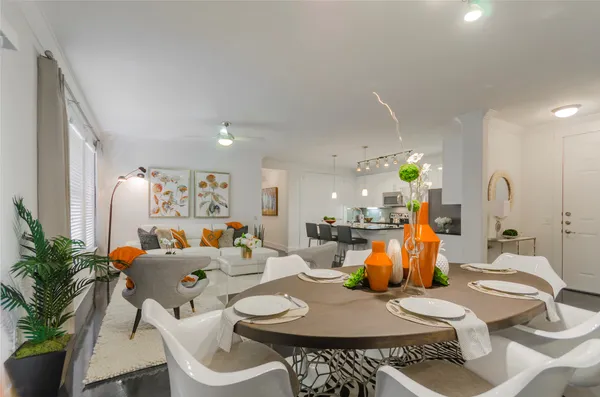a dining room with furniture and wooden floor