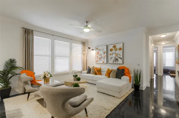a living room with furniture and large windows