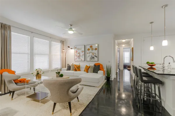 a living room with furniture and a large window