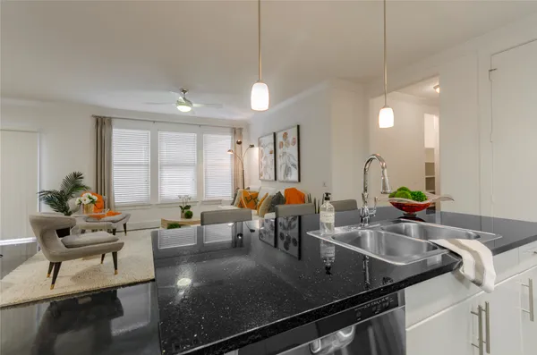 a kitchen with a sink dining table and chairs