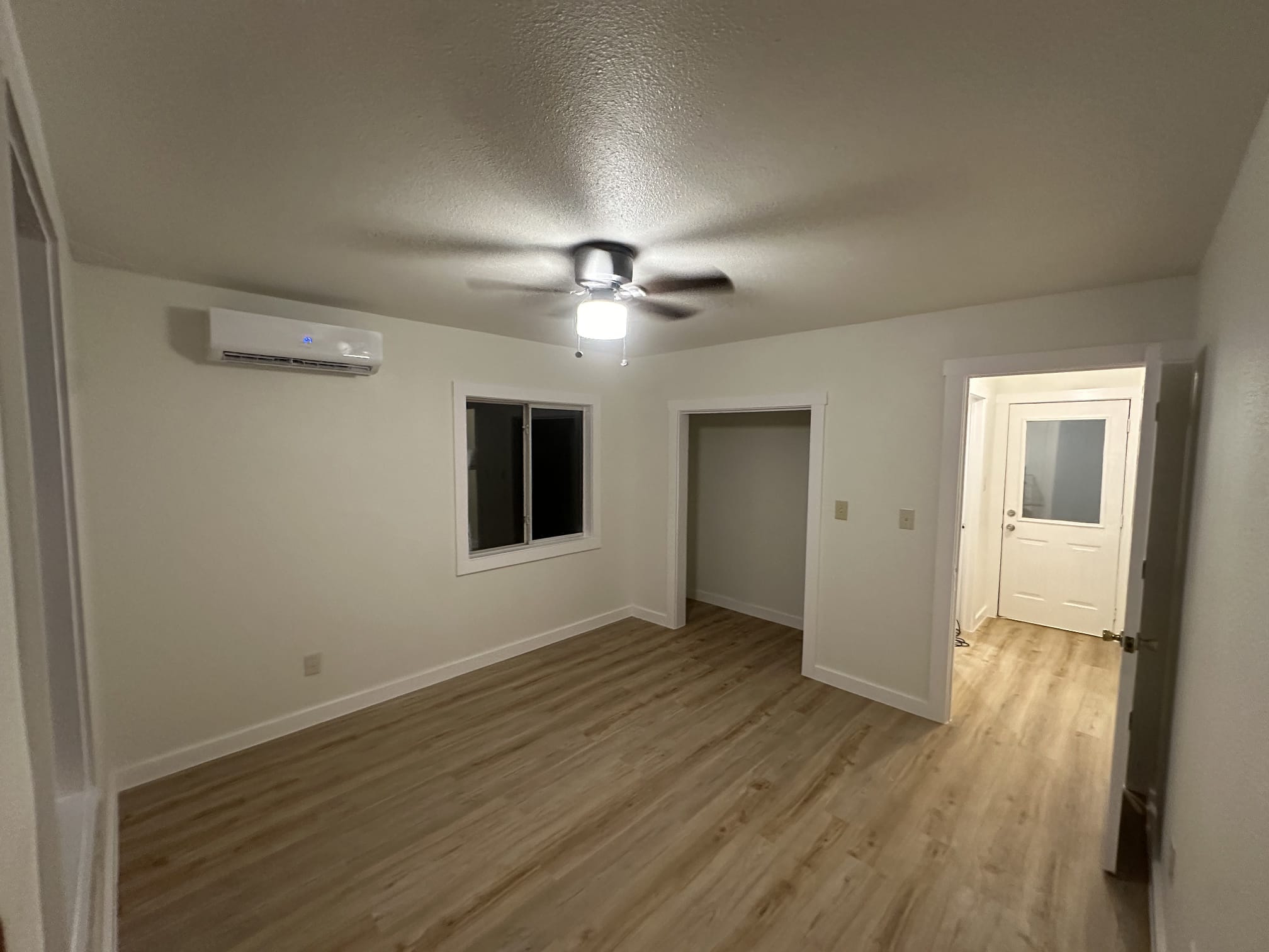 176 Old Lexington Road, Unit C Elgin, TX 78621 - Photo 29 of 31 a view of an empty room with wooden floor and a window