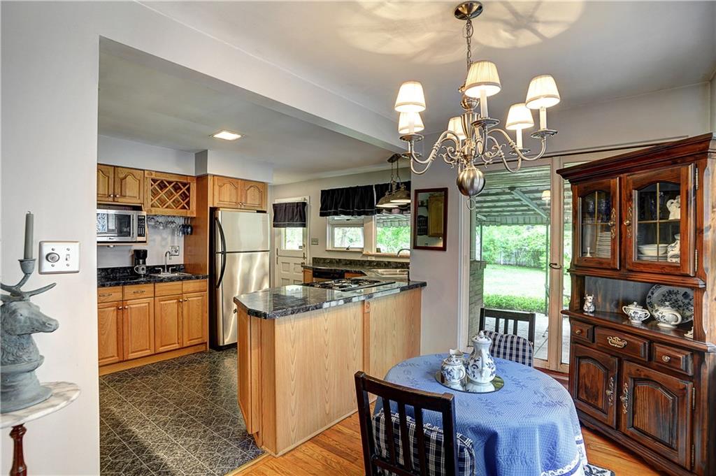 205 Quaker Road Sewickley, PA 15143 - Photo 6 of 18 Dining Room opens to kitchen with stainless appliances and unique dutch door
