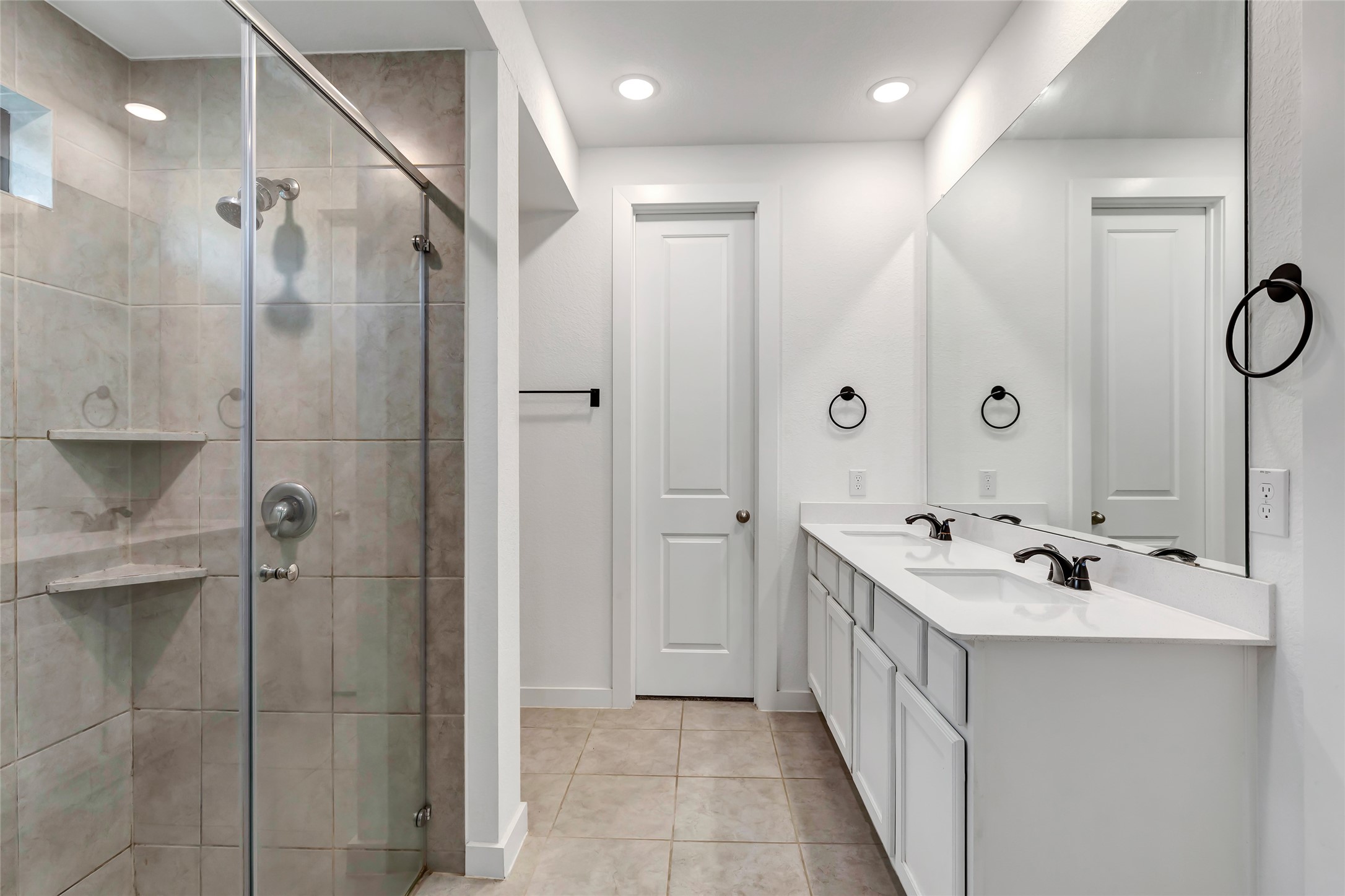 527 Chestnut Reef Court Conroe, TX 77304 - Photo 22 of 40 a bathroom with a double vanity sink mirror and shower
