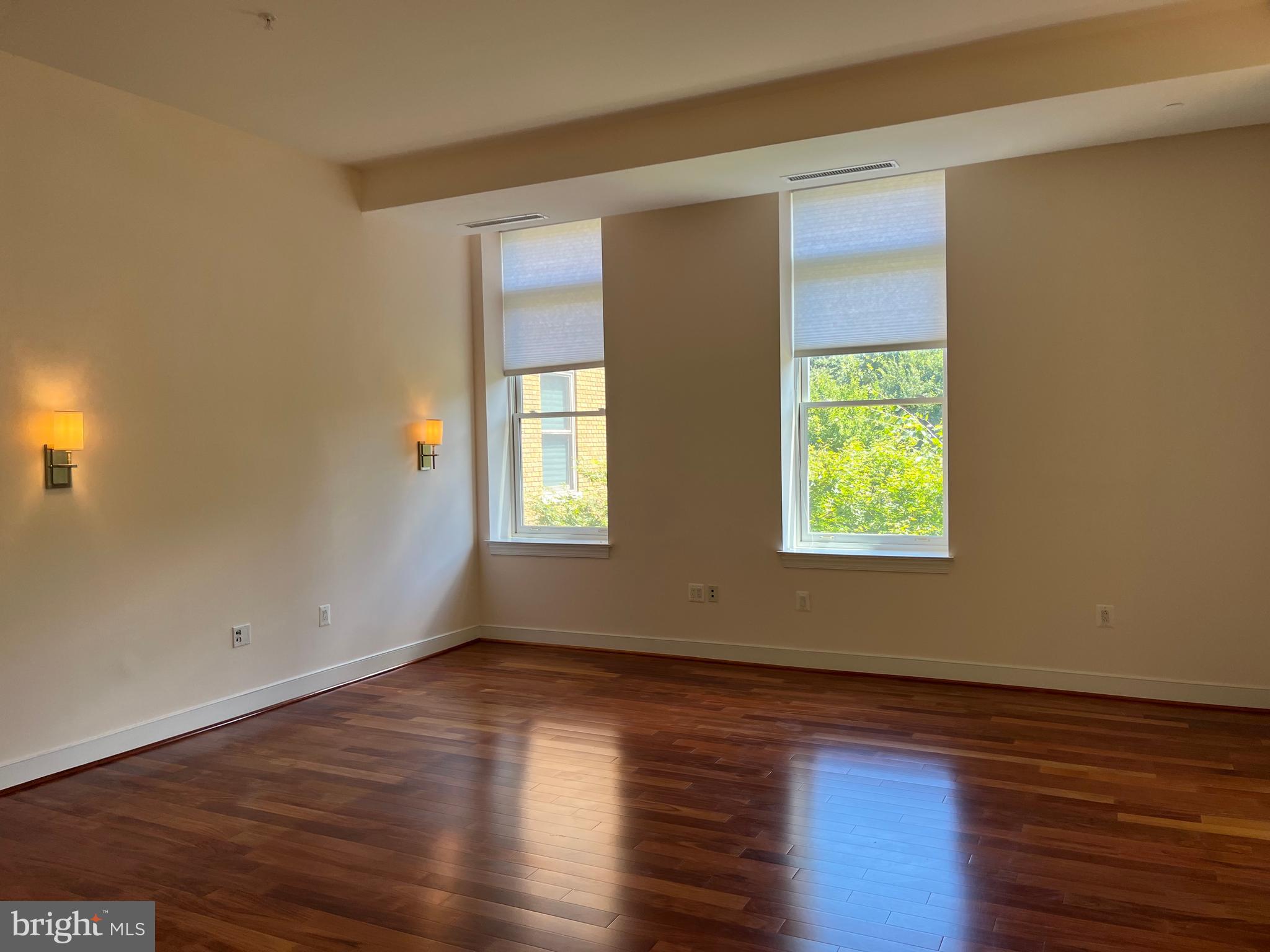 2425 L Street Northwest, Unit 215 Washington, DC 20037 - Photo 13 of 38 a view of an empty room with wooden floor and a window