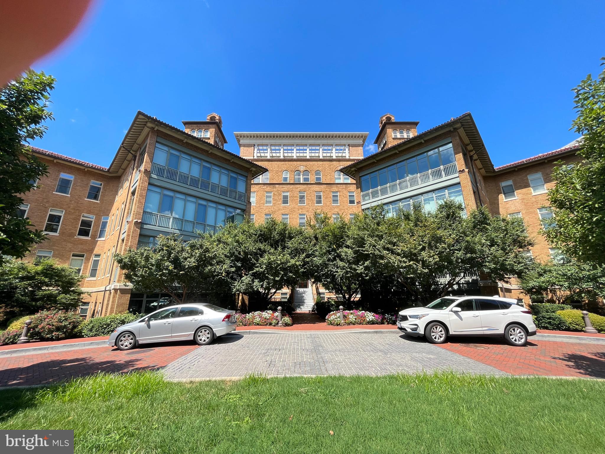 2425 L Street Northwest, Unit 215 Washington, DC 20037 - Photo 2 of 38 a view of a car parked in front of a house