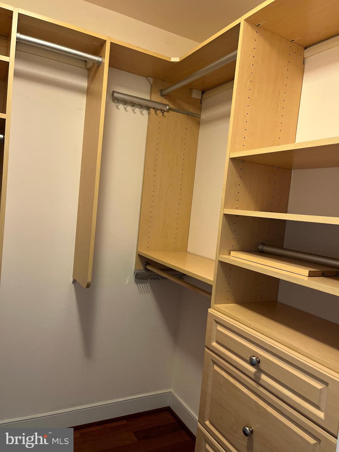 2425 L Street Northwest, Unit 215 Washington, DC 20037 - Photo 25 of 38 a view of walk in closet with empty racks