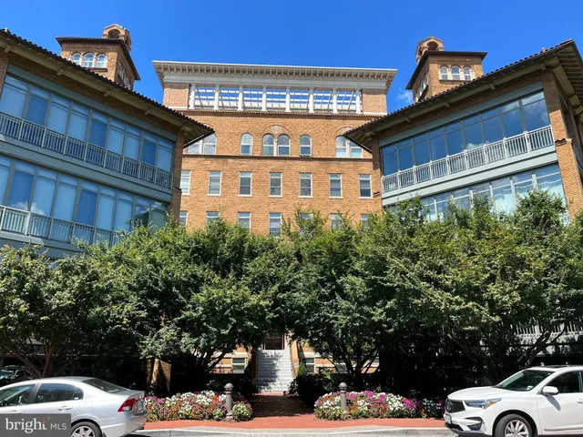 a front view of a building with trees