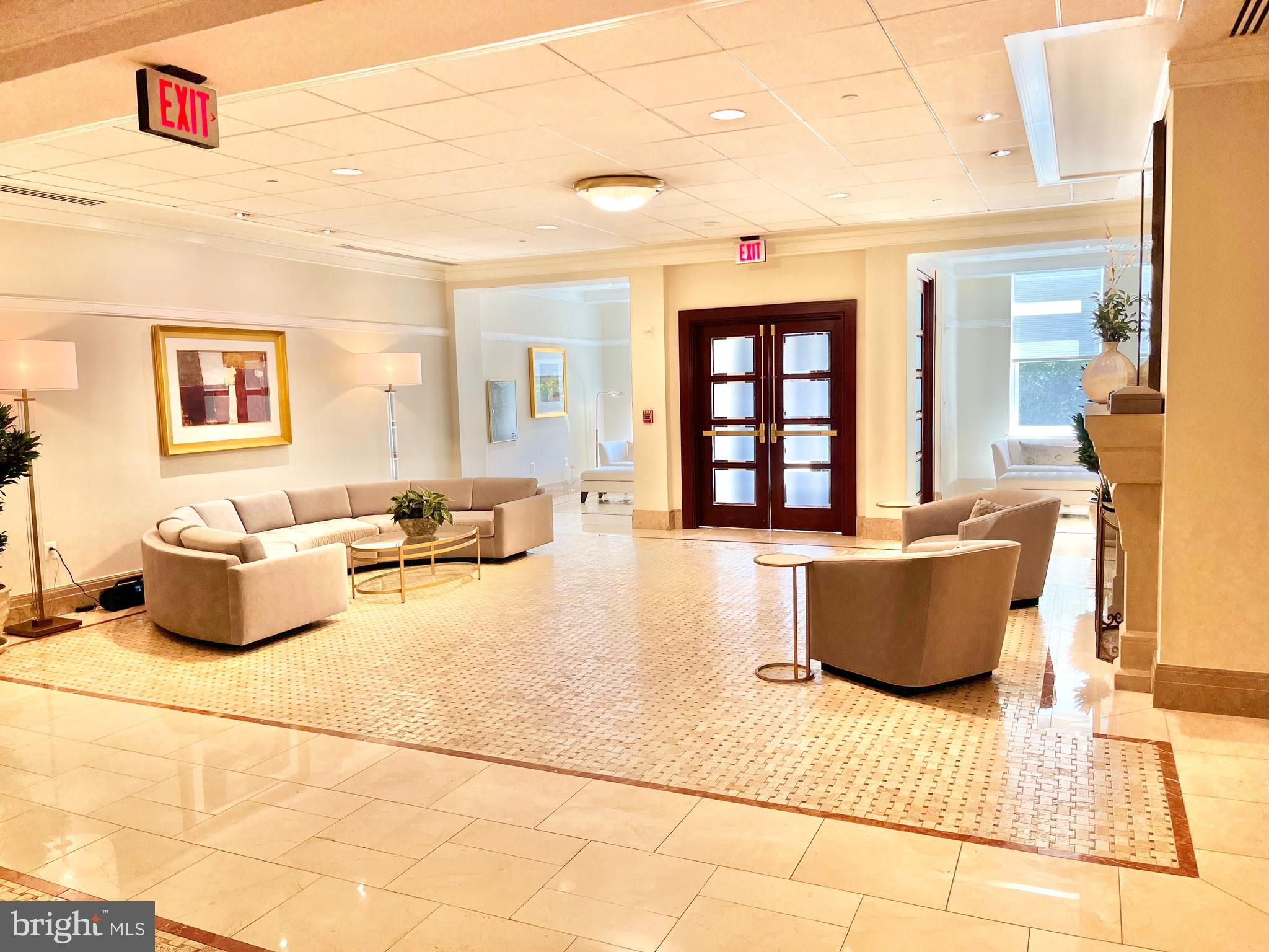 2425 L Street Northwest, Unit 215 Washington, DC 20037 - Photo 33 of 38 a living room with furniture and a flat screen tv