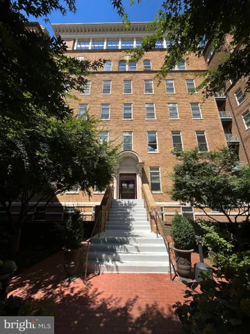 a view of a brick building next to a yard