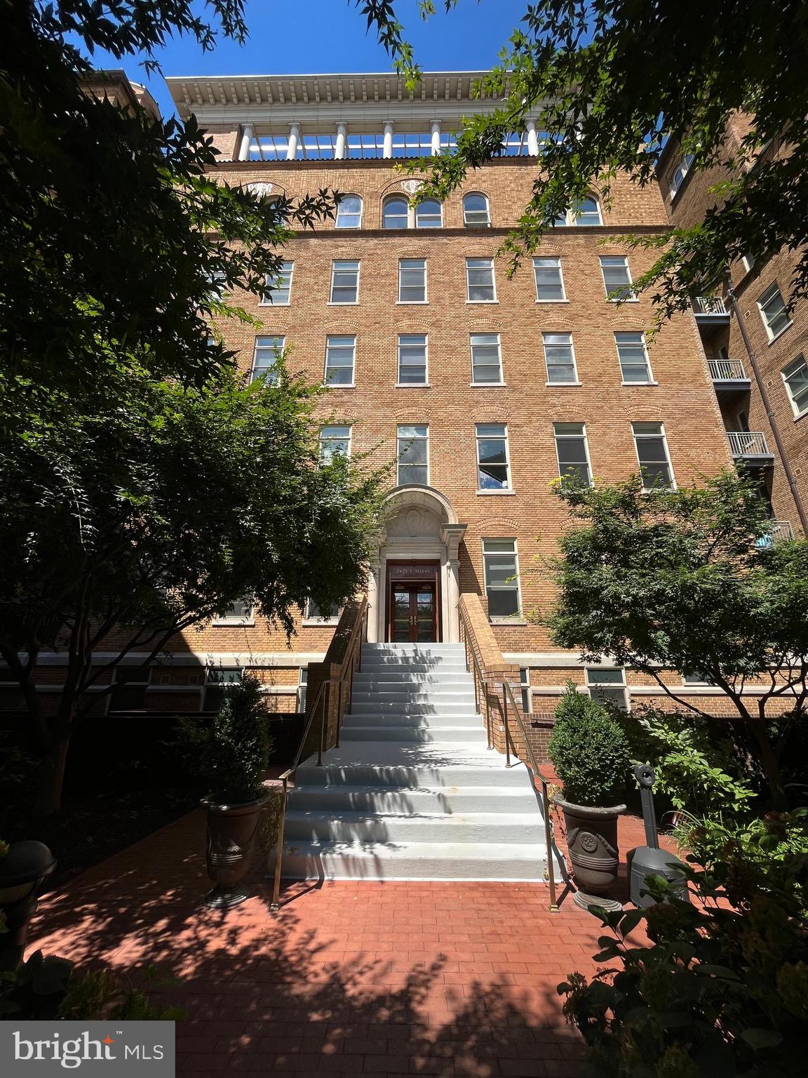 2425 L Street Northwest, Unit 215 Washington, DC 20037 - Photo 6 of 38 a view of a brick building next to a yard