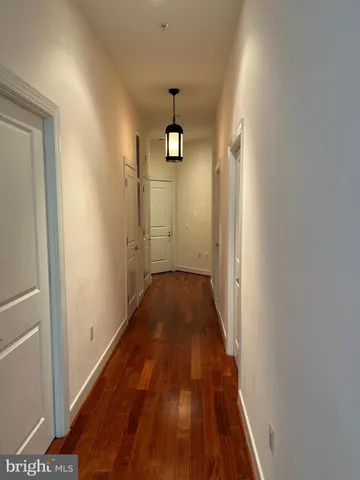 a view of a hallway with wooden floor