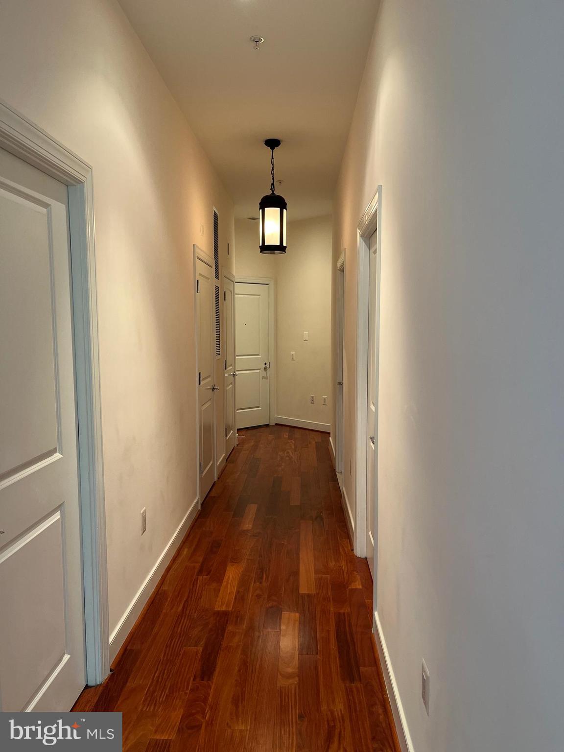 2425 L Street Northwest, Unit 215 Washington, DC 20037 - Photo 8 of 38 a view of a hallway with wooden floor