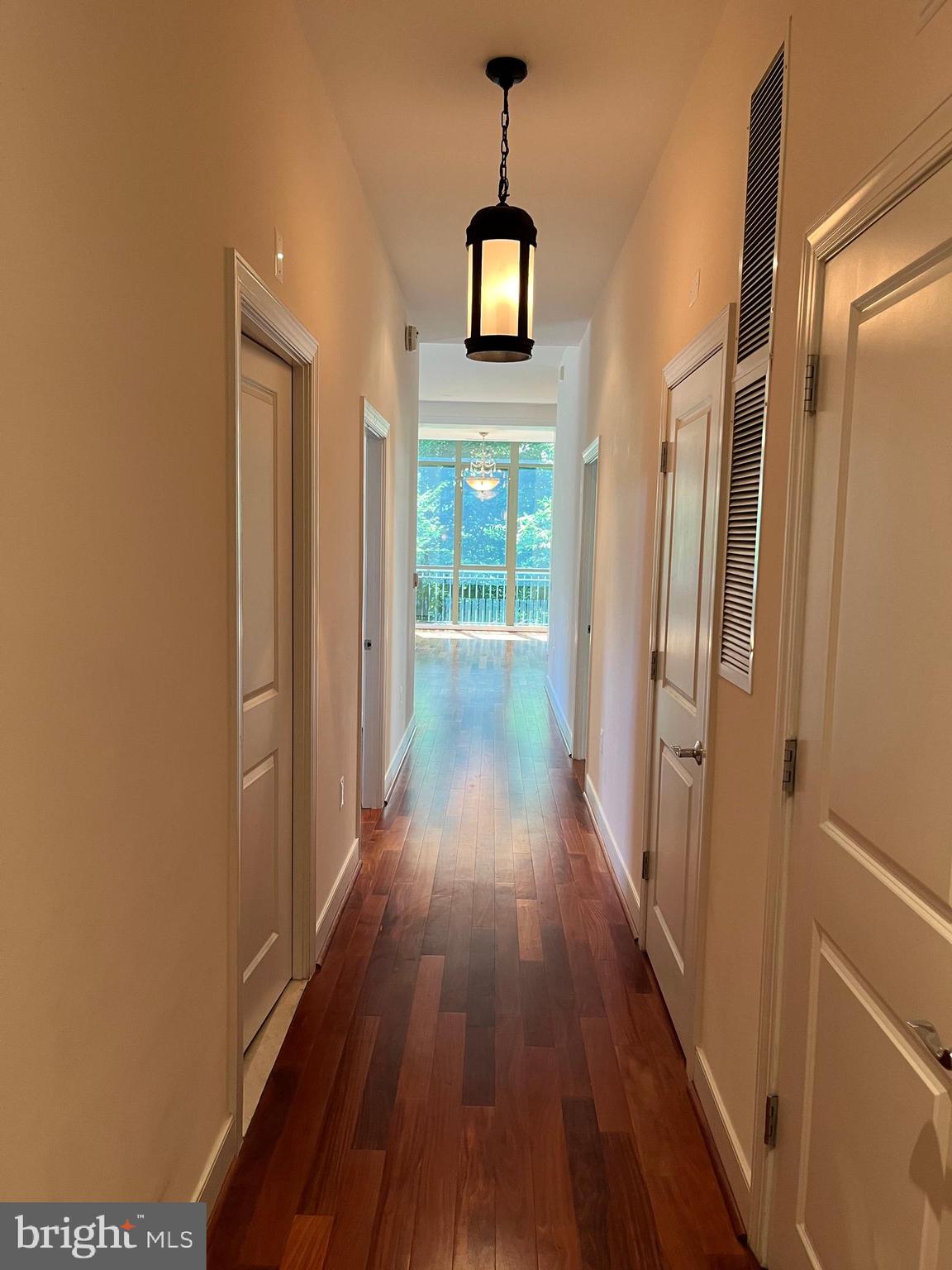 2425 L Street Northwest, Unit 215 Washington, DC 20037 - Photo 9 of 38 a view of a hallway with wooden floor and staircase