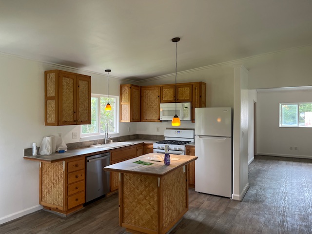 14-3417 Molokai Road Pahoa, HI 96778 - Photo 3 of 11 a kitchen with a sink a refrigerator a stove and cabinets