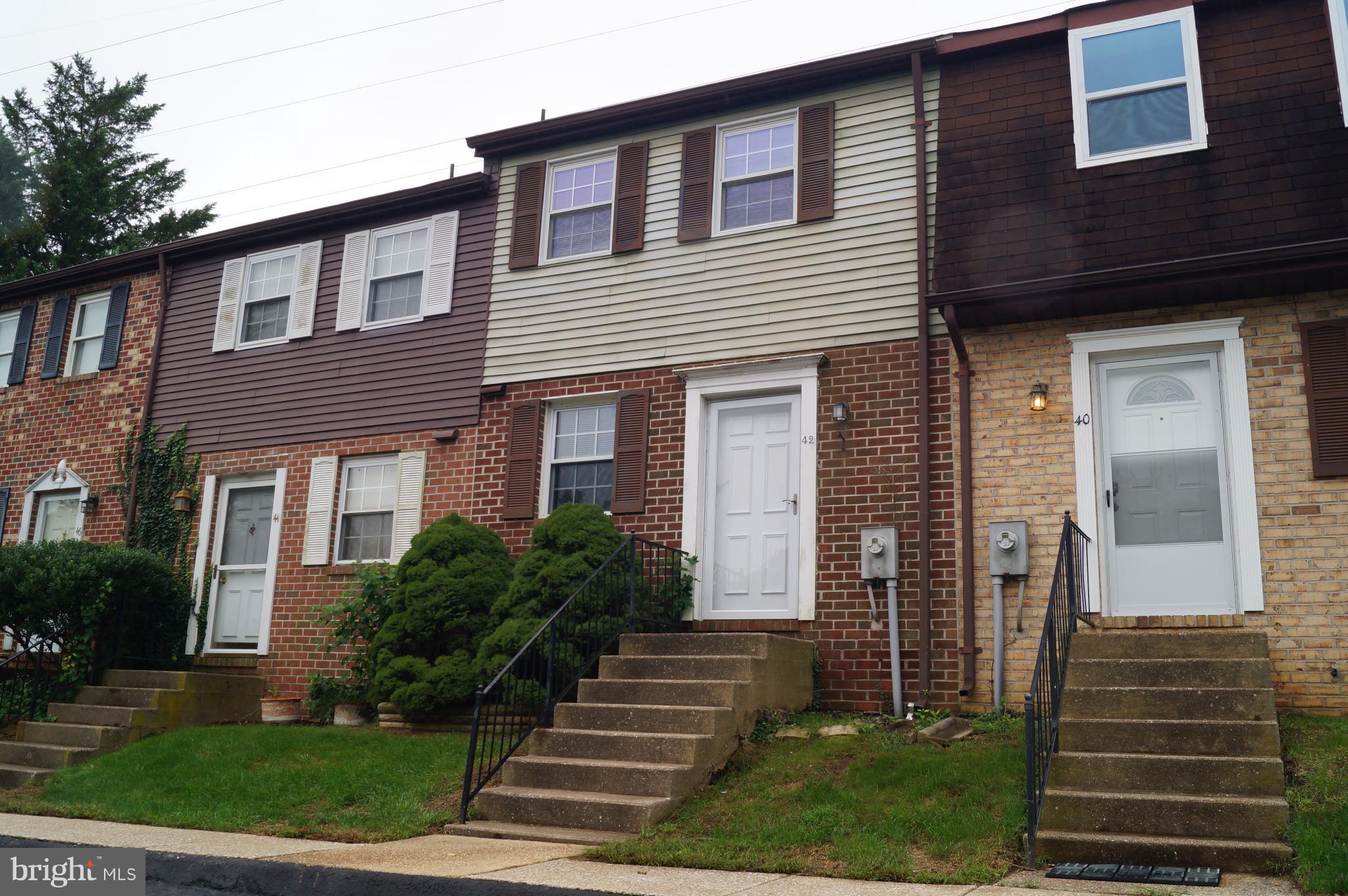 42 Ritters Ridge Court Owings Mills, MD 21117 - Photo 1 of 12 a front view of a house with a yard