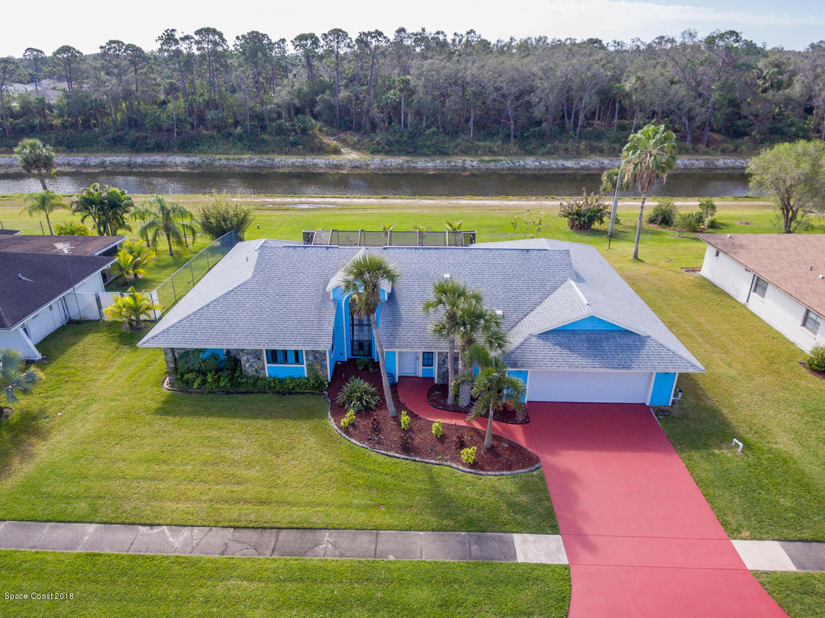 1508 Meadowbrook Road Northeast Palm Bay, FL 32905 - Photo 1 of 42 a view of a swimming pool with a yard and a swimming pool