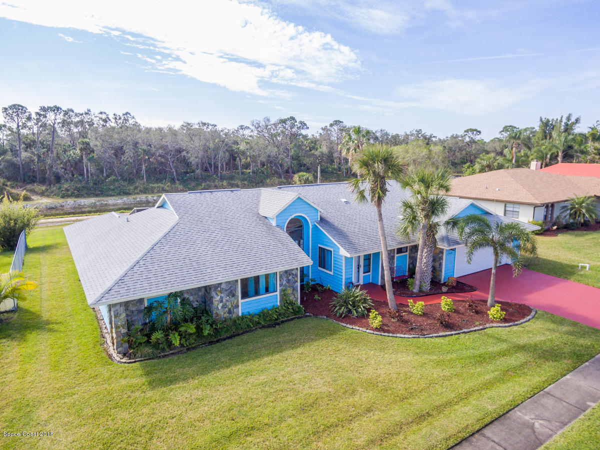 1508 Meadowbrook Road Northeast Palm Bay, FL 32905 - Photo 3 of 42 an aerial view of a house with swimming pool garden and patio
