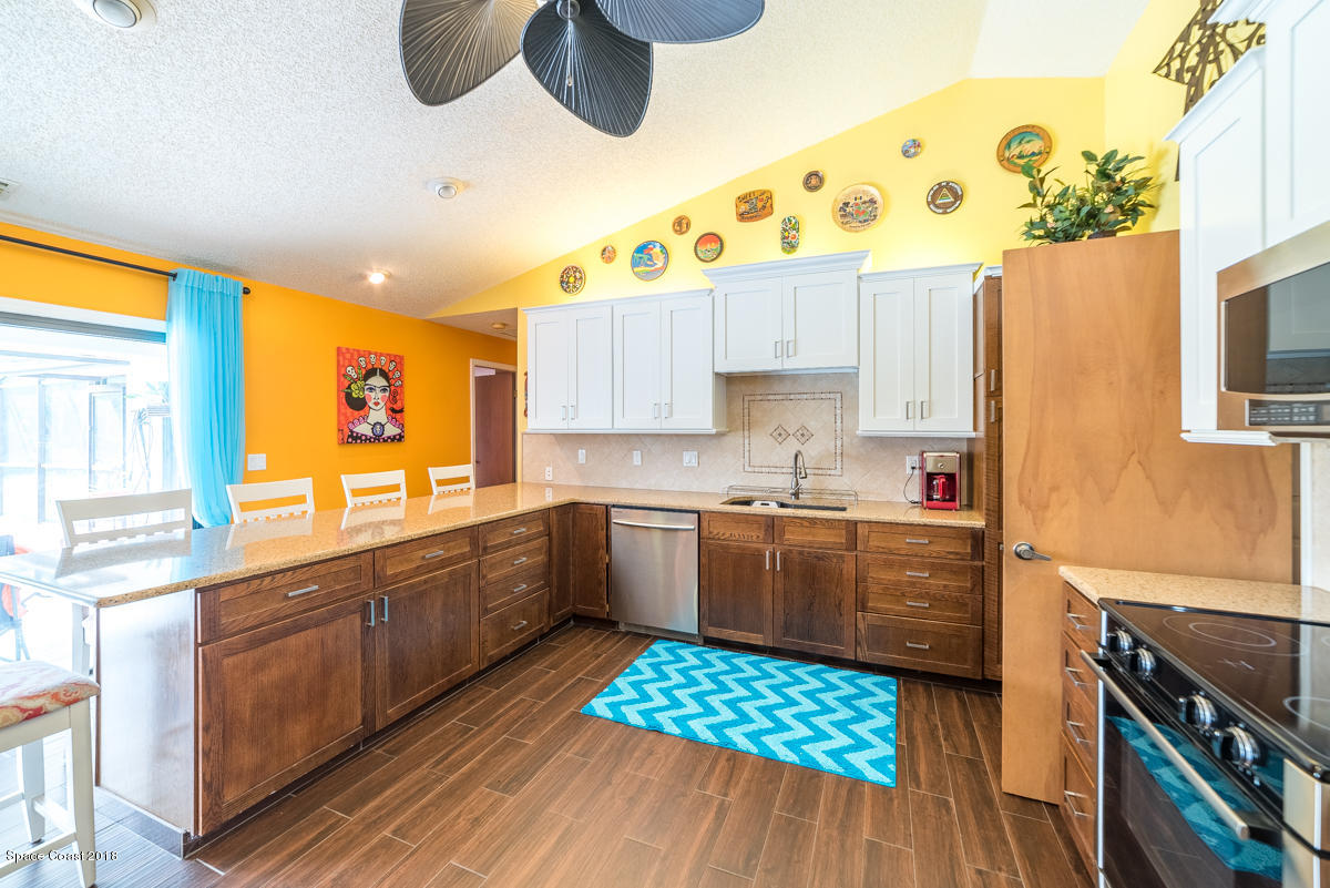 1508 Meadowbrook Road Northeast Palm Bay, FL 32905 - Photo 26 of 42 a kitchen with a sink and a stove