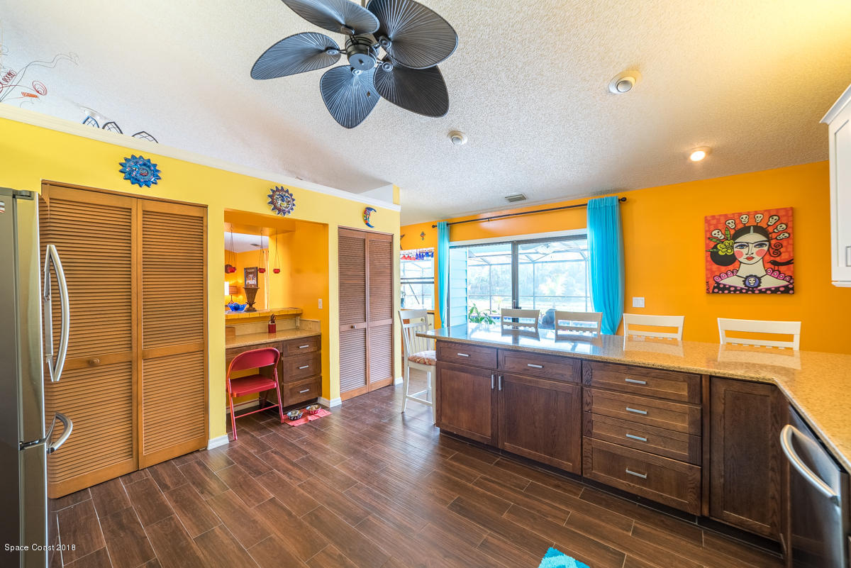 1508 Meadowbrook Road Northeast Palm Bay, FL 32905 - Photo 27 of 42 a view of a livingroom with furniture window and wooden floor