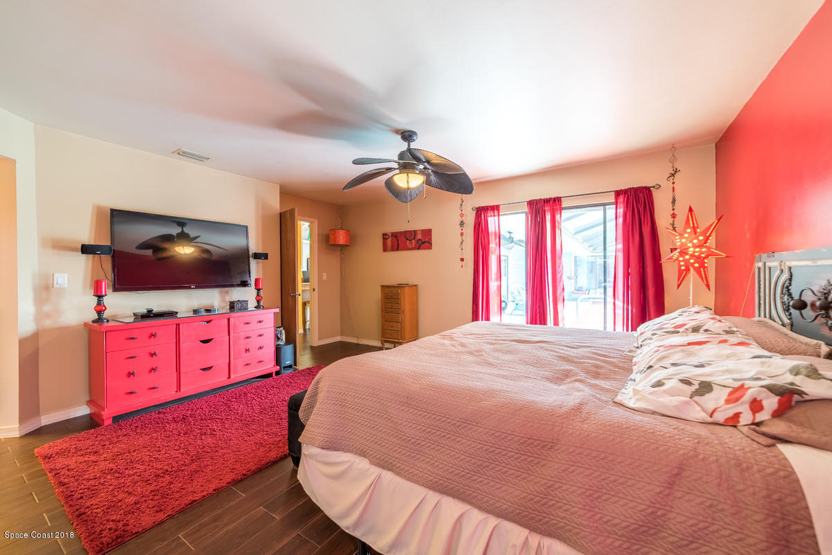 1508 Meadowbrook Road Northeast Palm Bay, FL 32905 - Photo 30 of 42 a bedroom with a bed and a flat screen tv