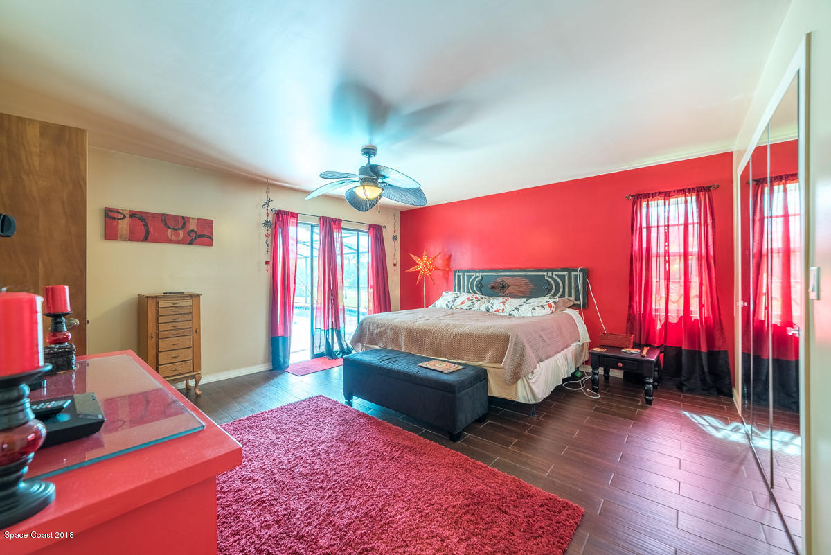 1508 Meadowbrook Road Northeast Palm Bay, FL 32905 - Photo 31 of 42 a spacious bedroom with a bed dresser and a window