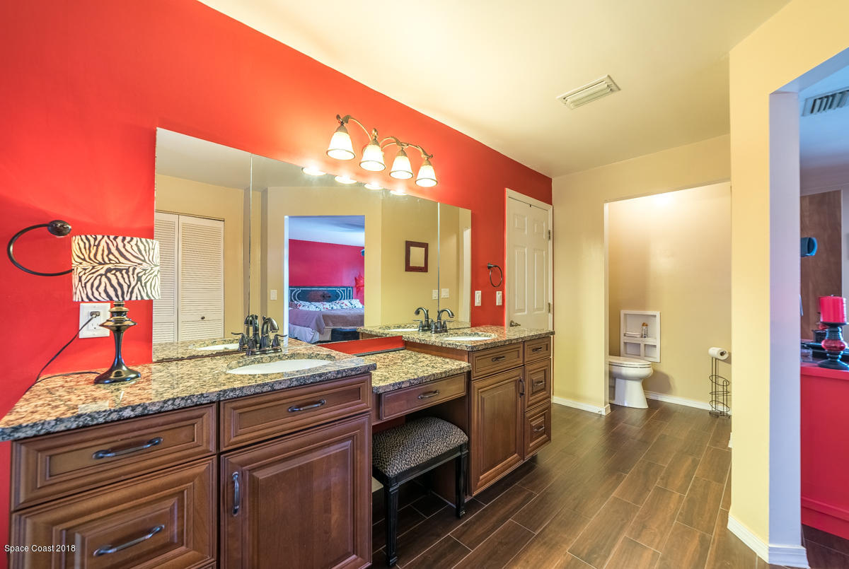 1508 Meadowbrook Road Northeast Palm Bay, FL 32905 - Photo 34 of 42 a bathroom with a sink and a mirror