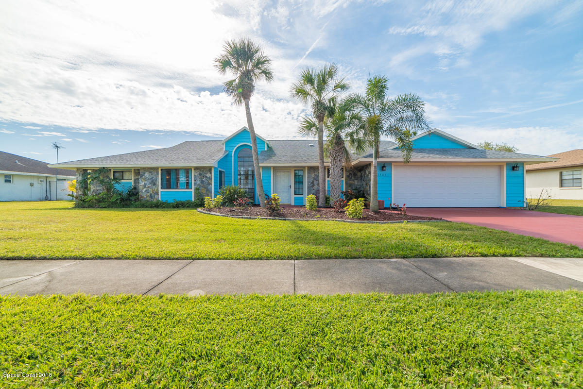 1508 Meadowbrook Road Northeast Palm Bay, FL 32905 - Photo 5 of 42 a front view of a house with a yard and potted plants