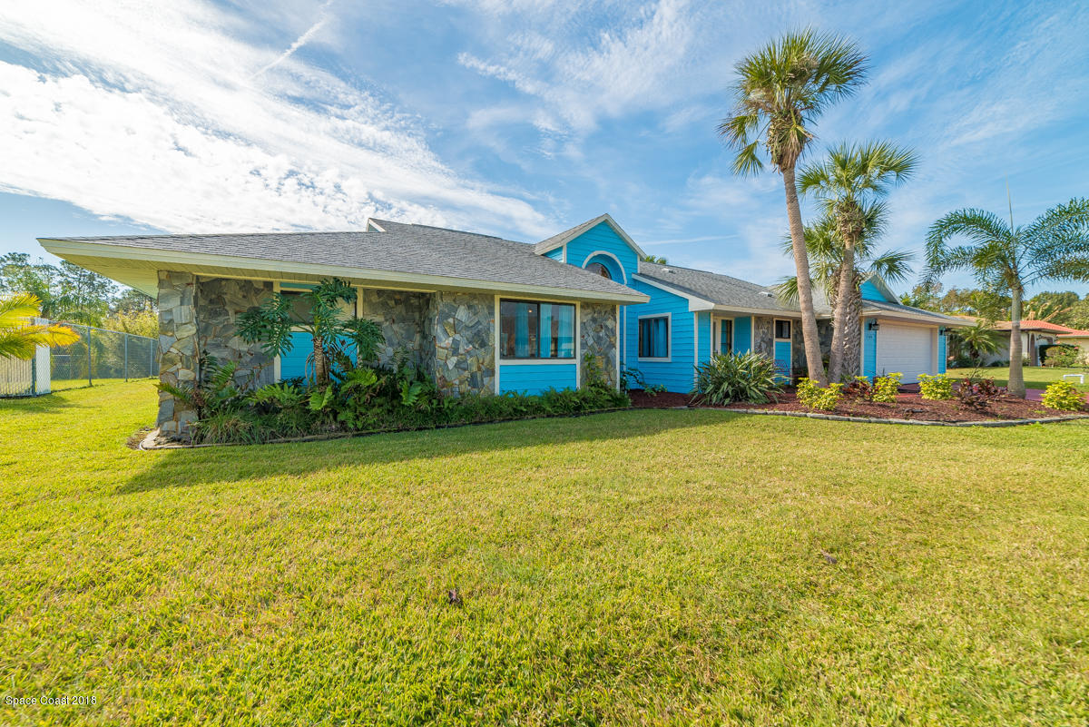 1508 Meadowbrook Road Northeast Palm Bay, FL 32905 - Photo 6 of 42 a front view of a house with garden