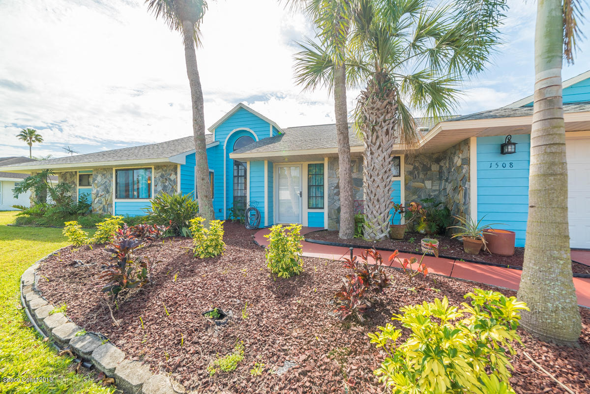 1508 Meadowbrook Road Northeast Palm Bay, FL 32905 - Photo 7 of 42 a front view of a house with garden