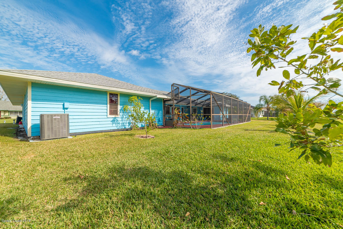 1508 Meadowbrook Road Northeast Palm Bay, FL 32905 - Photo 8 of 42 a front view of a house with a yard