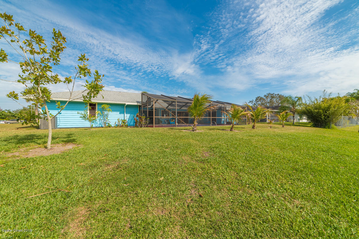 1508 Meadowbrook Road Northeast Palm Bay, FL 32905 - Photo 9 of 42 a front view of a house with garden