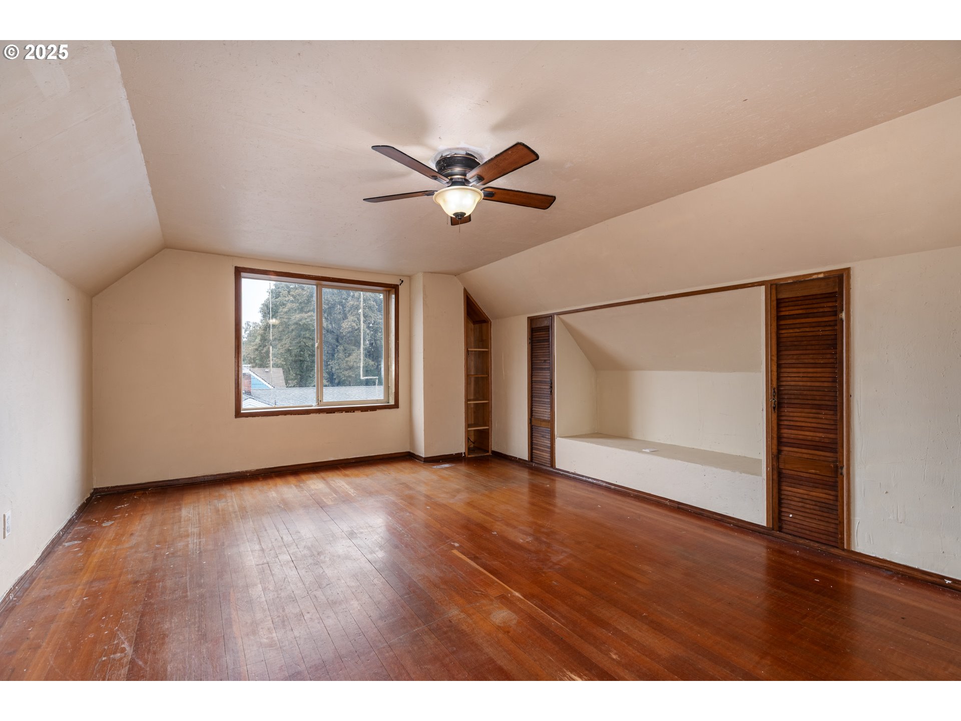 169 MacArthur Street St. Helens, OR 97051 - Photo 12 of 31 a view of an empty room with a window and wooden floor