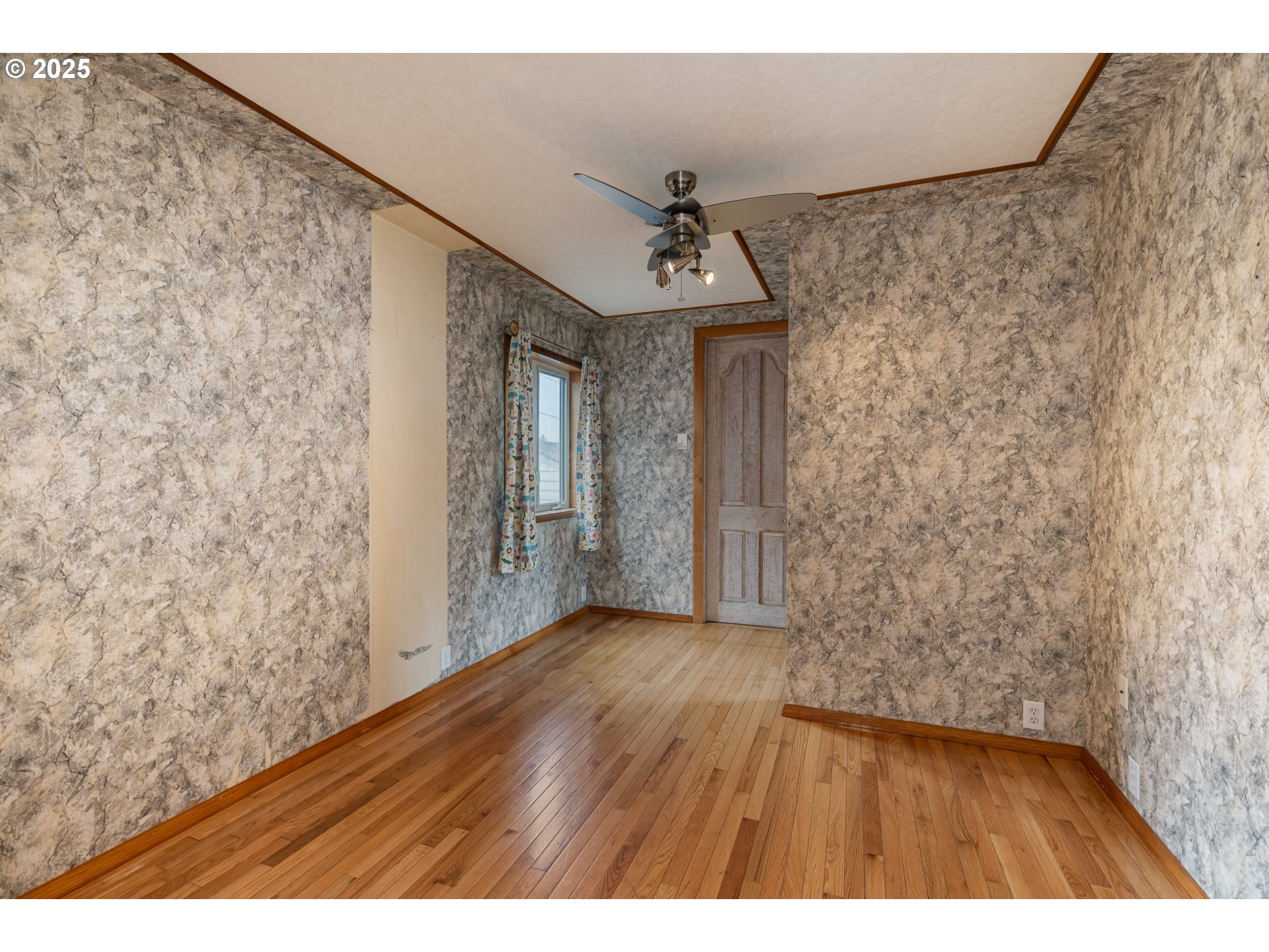 169 MacArthur Street St. Helens, OR 97051 - Photo 17 of 31 a view of a hallway with wooden floor and a ceiling fan