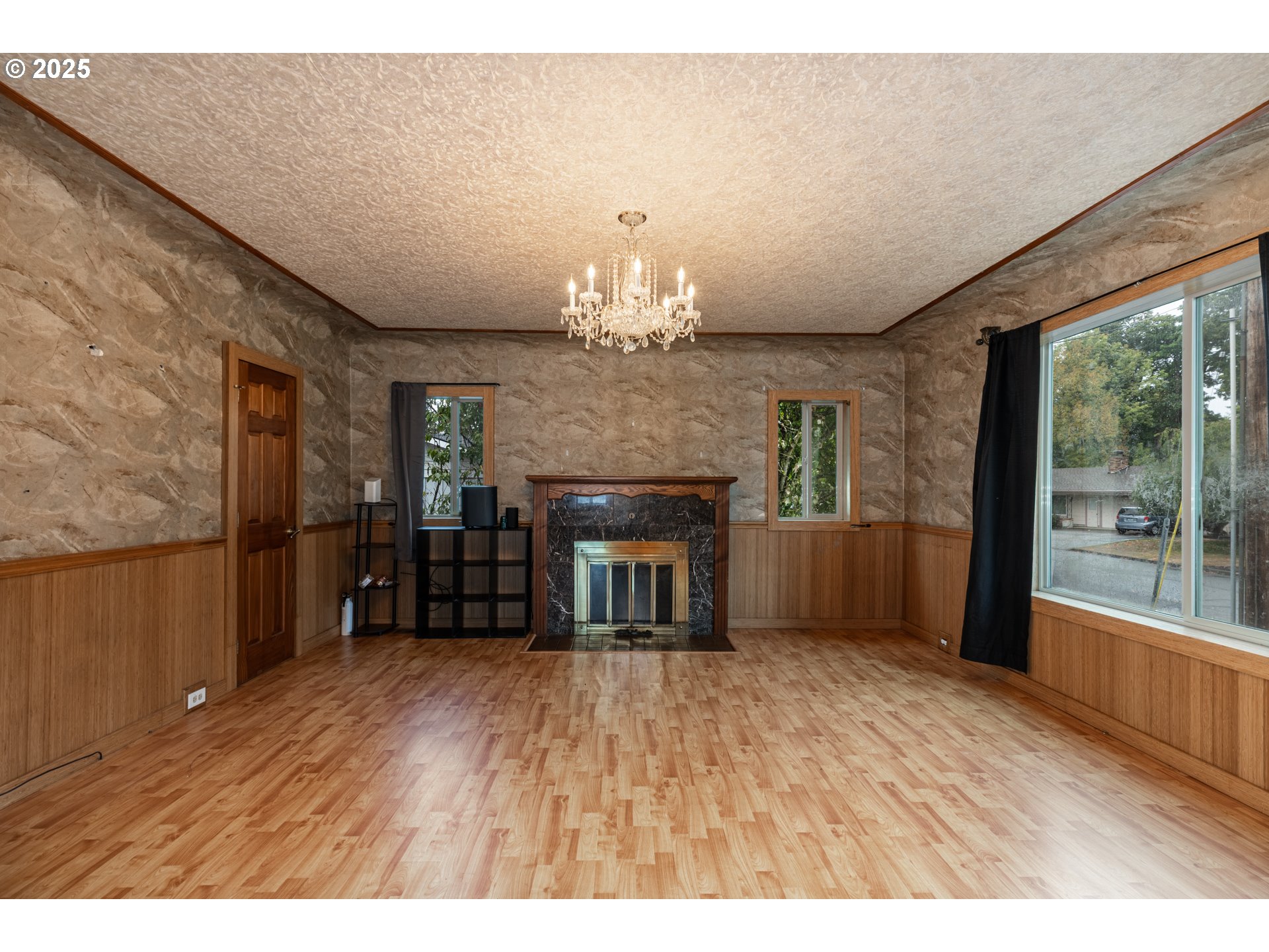 169 MacArthur Street St. Helens, OR 97051 - Photo 7 of 31 a view of an empty room with wooden floor fireplace and a window