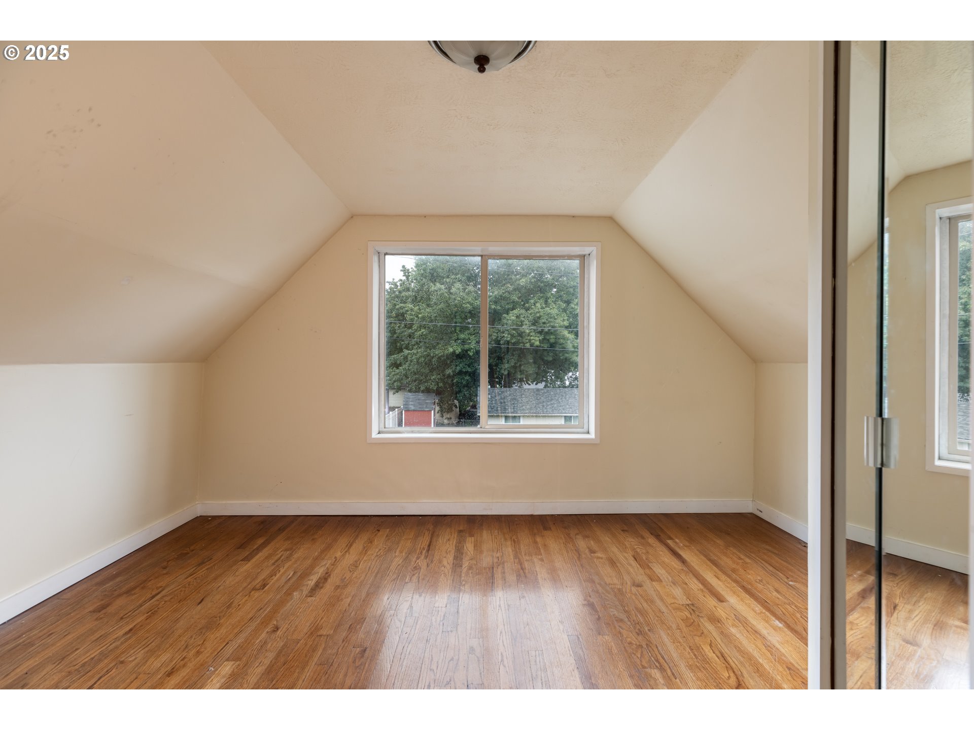 169 MacArthur Street St. Helens, OR 97051 - Photo 10 of 31 a view of an empty room with wooden floor and a window