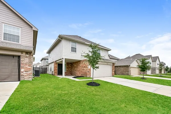 a front view of house with yard and green space