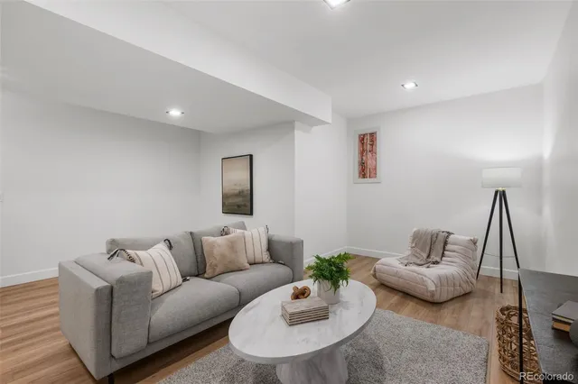 a living room with furniture and a wooden floor