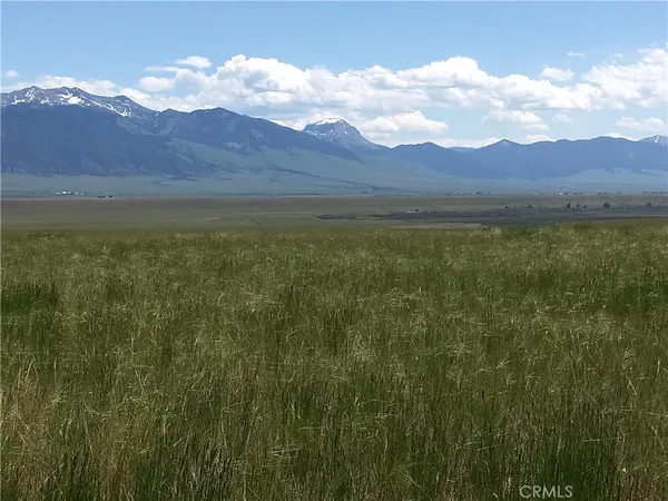 a view of a large mountain with mountains in the background