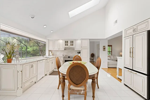 a dining room with furniture and a large window